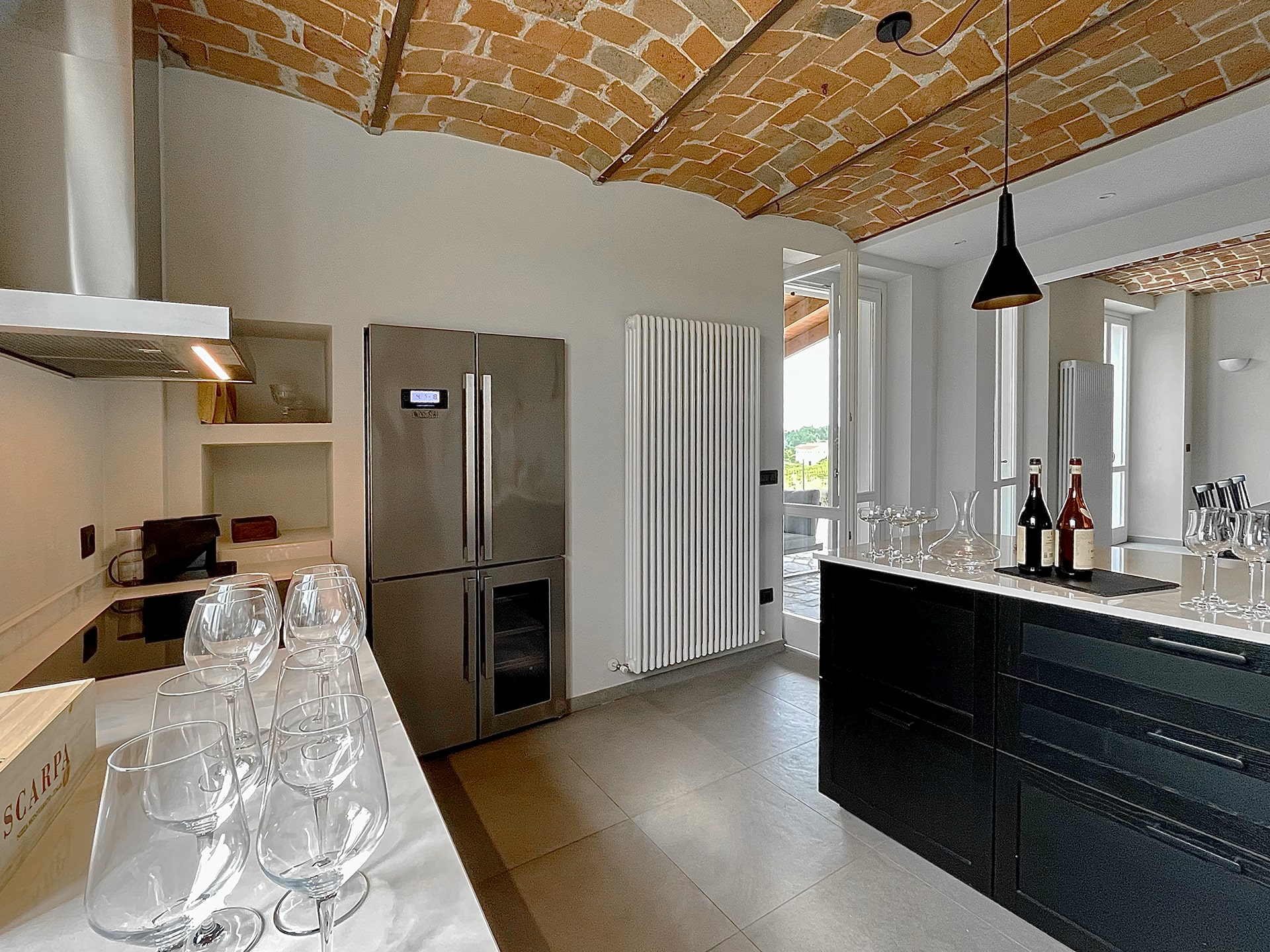 Fully equipped kitchen with wine glasses and vaulted ceiling