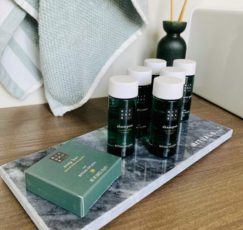 Bathroom amenities arranged on a stone tray